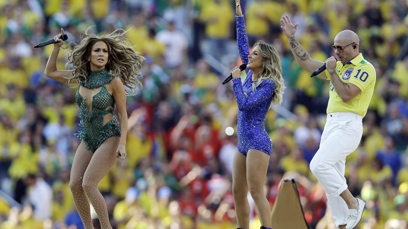 US singer Jennifer Lopez, left, rapper Pitbull and Brazilian singer Claudia Leitte perform during the opening ceremony ahead of the group A World Cup soccer match between Brazil and Croatia, the opening game of the tournament, in the Itaquerao Stadium in Sao Paulo, Brazil, Thursday, June 12, 2014. (AP Photo/Kirsty Wigglesworth)
