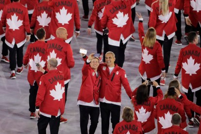 Members of team Canada take a selfie during the opening ceremony of the 2016 Summer Olympics in Rio de Janeiro, Brazil, Friday, Aug. 5, 2016. (AP Photo/Charlie Riedel)