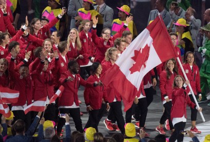 Rosie MacLennan carries the flag as she leads Canada into the opening ceremonies for the 2016 Summer Olympics Friday August 5, 2016 in Rio de Janeiro, Brazil. THE CANADIAN PRESS/Frank Gunn