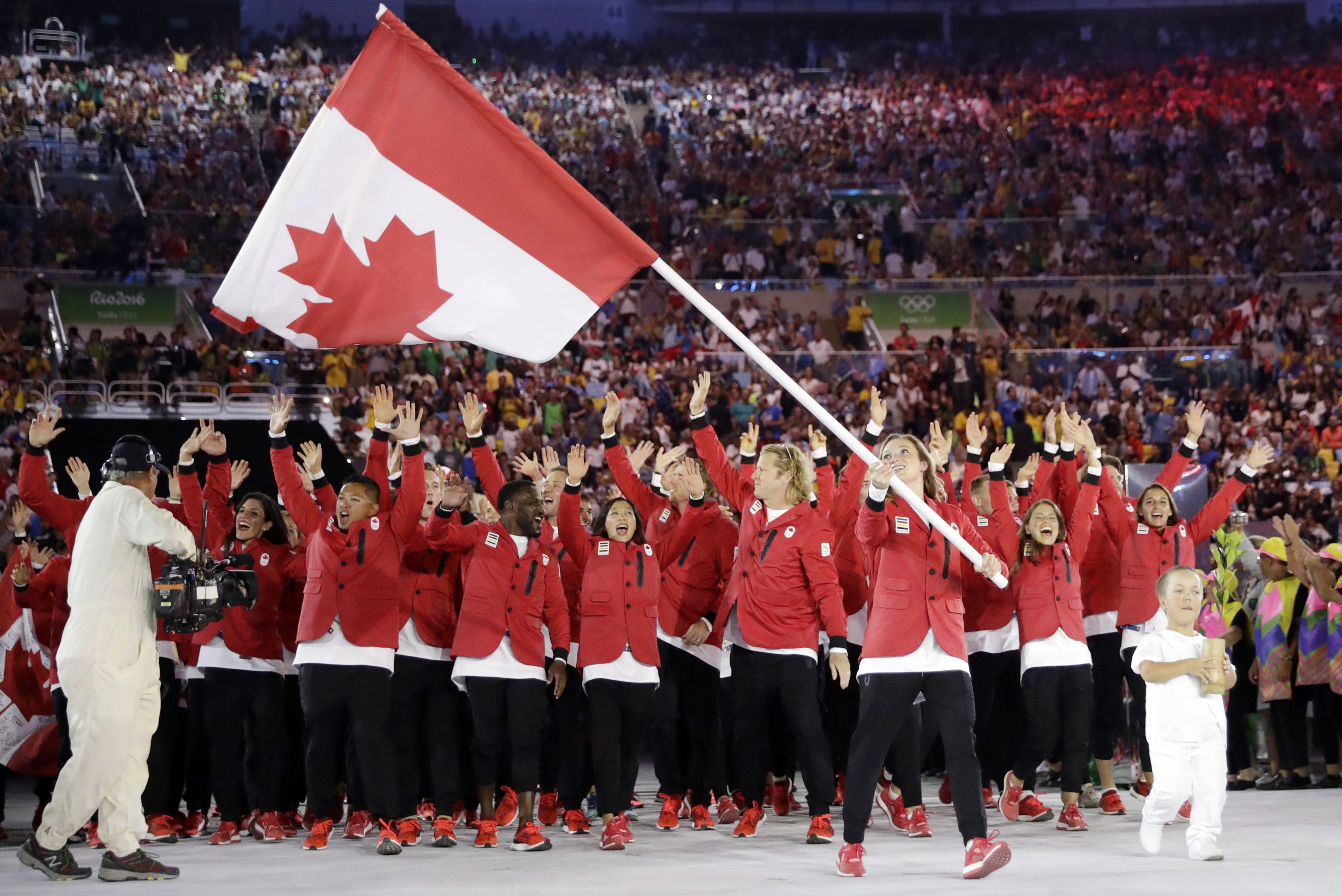 Rosannagh Maclennan carries the flag of Canada during the opening ceremony for the 2016 Summer Olympics in Rio de Janeiro, Brazil, Friday, Aug. 5, 2016. (AP Photo/David J. Phillip)
