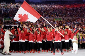 Rosannagh Maclennan carries the flag of Canada during the opening ceremony for the 2016 Summer Olympics in Rio de Janeiro, Brazil, Friday, Aug. 5, 2016. (AP Photo/David J. Phillip)
