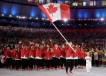 Rosie MacLennan carries Canadian flag at opening ceremony