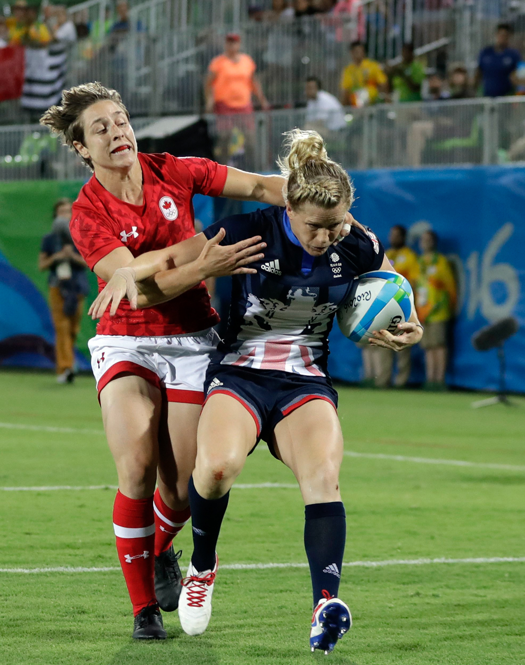 Great Britain's Danielle Waterman, right, avoids a tackle from Canada's Ghislaine Landry, to score a try during the women's rugby sevens bronze medal match at the Summer Olympics in Rio de Janeiro, Brazil, Monday, Aug. 8, 2016. (AP Photo/Themba Hadebe)