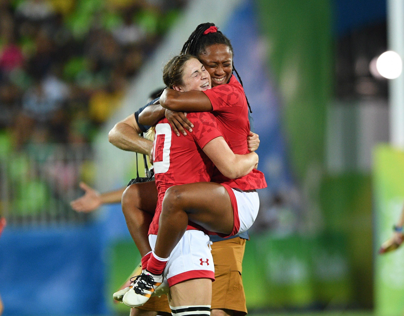 Canada's Charity Williams, right, jumps into the arms of Hannah Darling as they win bronze defeating Great Britain's in women's rugby sevens at the 2016 Olympic Summer Games in Rio de Janeiro, Brazil on Monday, Aug. 8, 2016. THE CANADIAN PRESS/Sean Kilpatrick