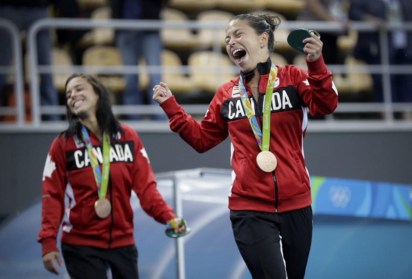 Canada's bronze medalists Roseline Filion, right, and Meaghan Benfeito celebrate after the women's synchronized 10-meter platform diving final in the Maria Lenk Aquatic Center at the 2016 Summer Olympics in Rio de Janeiro, Brazil, Tuesday, Aug. 9, 2016. (AP Photo/Wong Maye-E)