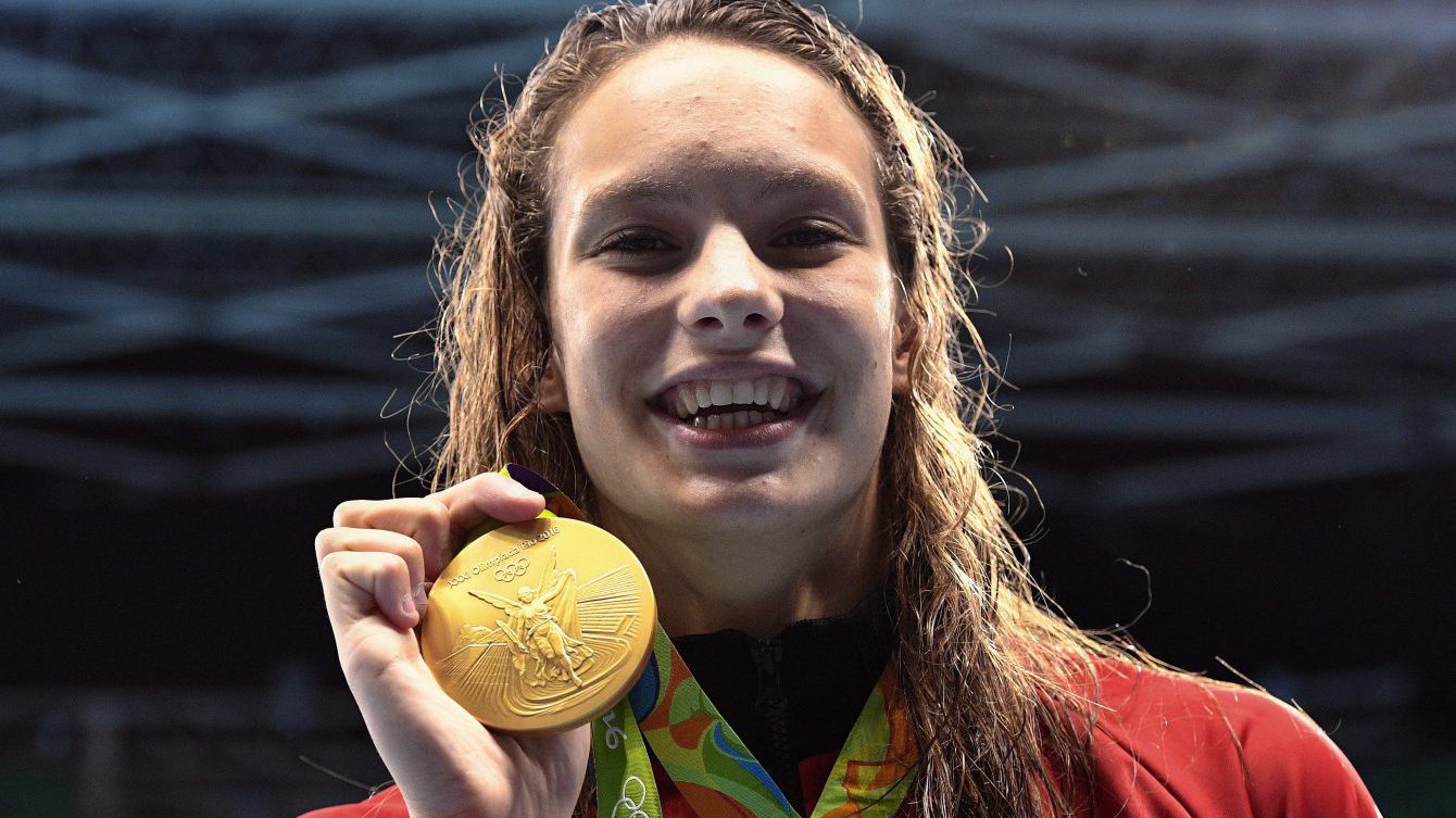 Canada's Penny Oleksiak holds up her gold medal after her first-place finish in the women's 100m freestyle finals during the 2016 Olympic Summer Games in Rio de Janeiro, Brazil, on Friday, Aug. 12, 2016. THE CANADIAN PRESS/Sean Kilpatrick