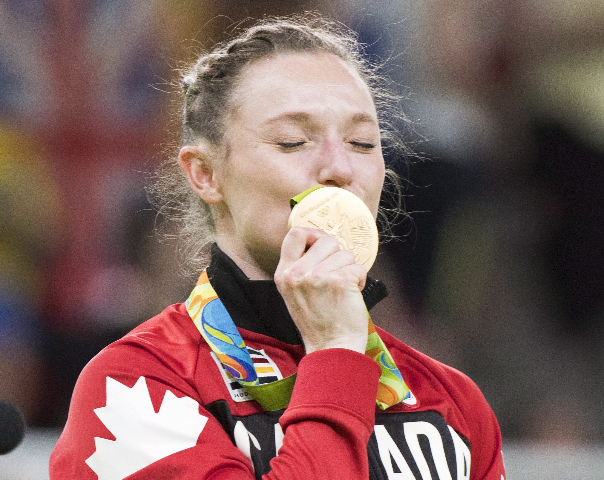Canada's Rosie MacLennan, from King City, Ont., kisses her gold medal after winning the trampoline gymnastics competition at the 2016 Summer Olympics Friday, August 12, 2016 in Rio de Janeiro, Brazil.THE CANADIAN PRESS/Ryan Remiorz