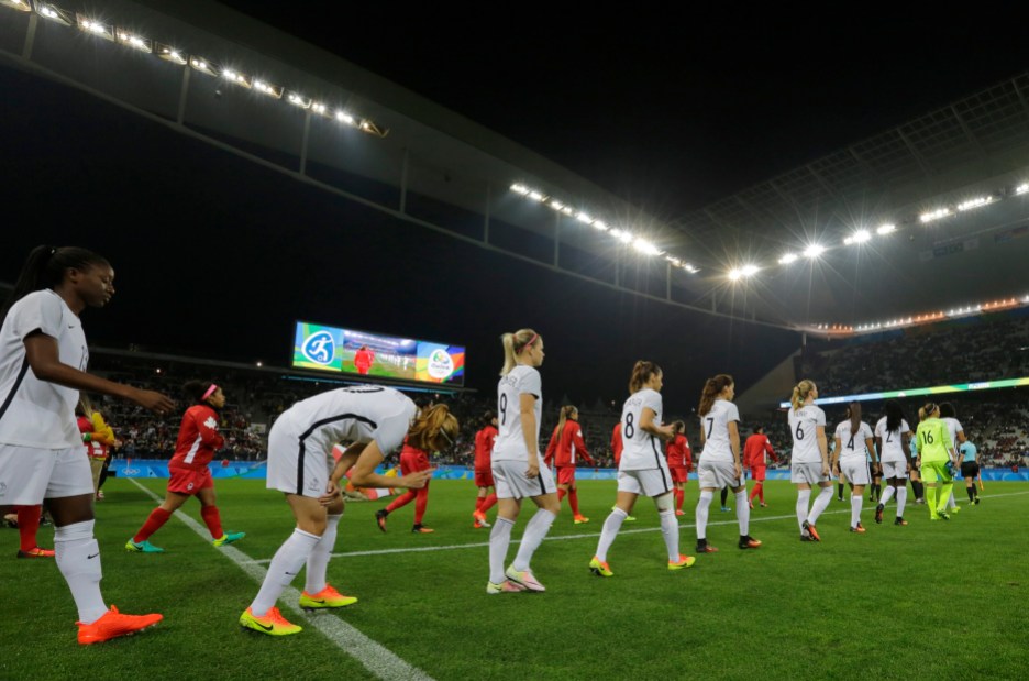 Rio Olympics Soccer Women Players enter the pitch before a quarter-final match of the women's Olympic football tournament between Canada and France in Sao Paulo, Brazil, Friday Aug. 12, 2016.(AP Photo/Nelson Antoine)