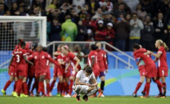 Rio 2016: Women's Soccer France's Amel Majri reacts in dejection as Canada's players celebrate after beating France in a quarter-final match of the women's Olympic football tournament between Canada and France in Sao Paulo, Brazil, Friday Aug. 12, 2016. Canada's won1-0 and went through to the semi-finals.(AP Photo/Nelson Antoine)