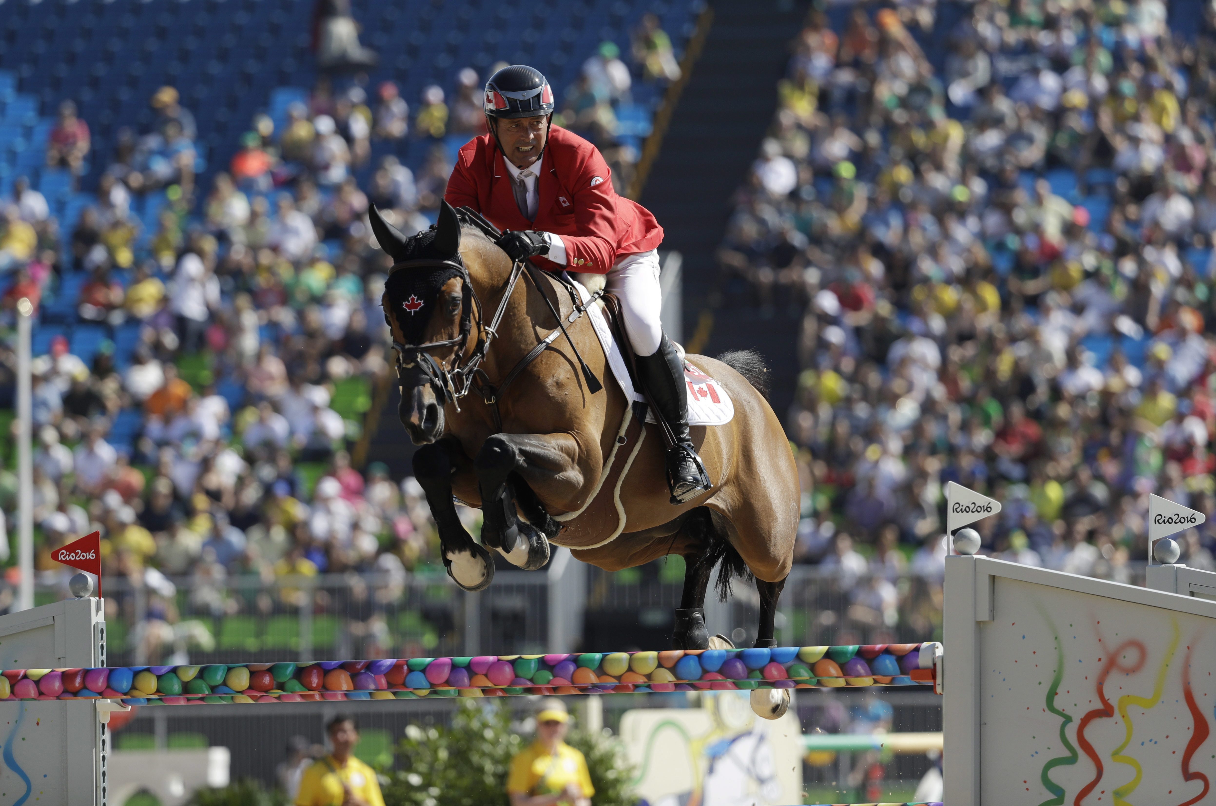 Canada's Yann Candele, riding First Choice 15, competes in the equestrian jumping competition at the 2016 Summer Olympics in Rio de Janeiro, Brazil, Sunday, Aug. 14, 2016. (AP Photo/John Locher)