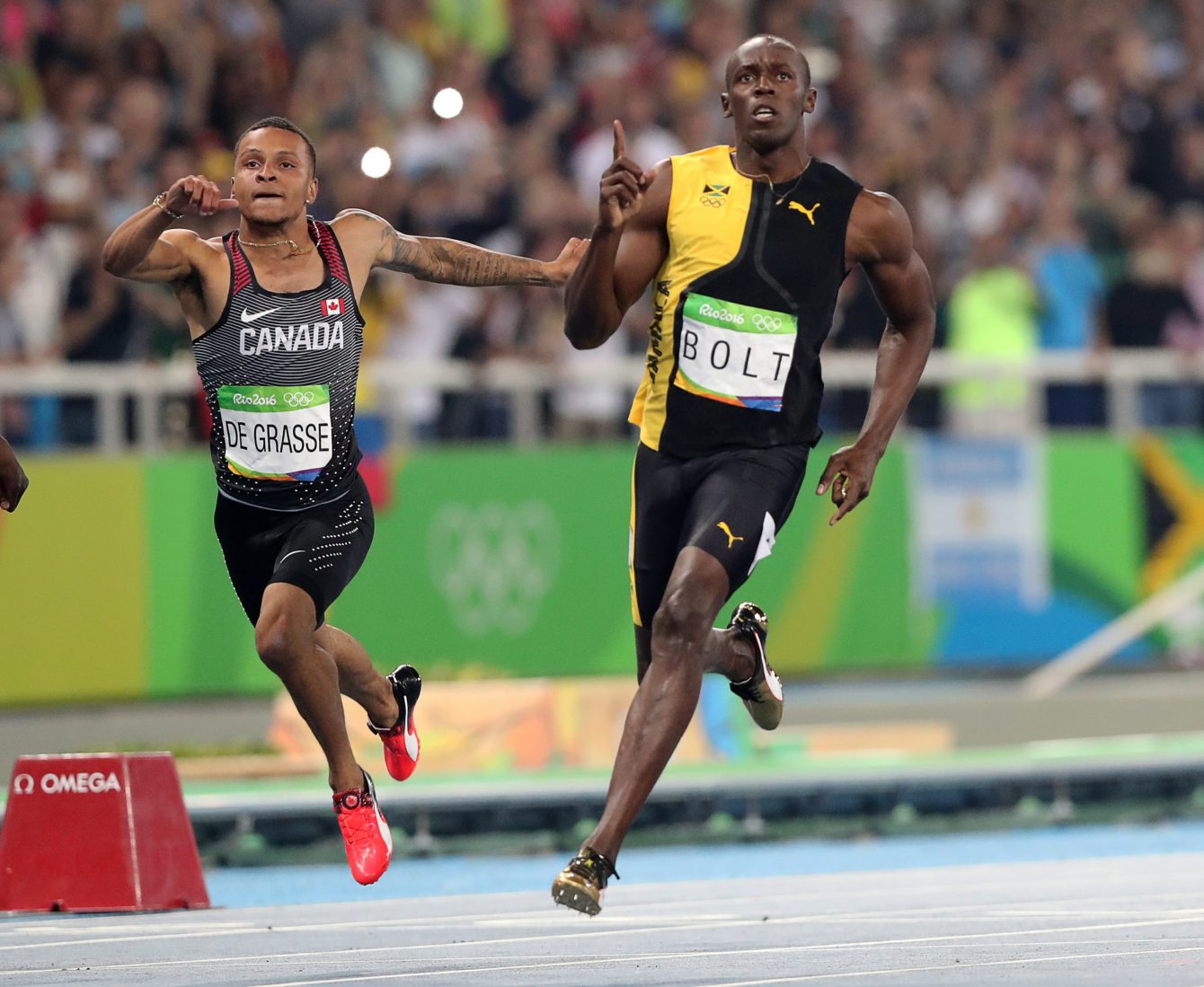 Jamaica's Usain Bolt celebrates as he crosses the line to win gold in the men's 100-meter final with Canada's Andre de Grasse during the athletics competitions of the 2016 Summer Olympics at the Olympic stadium in Rio de Janeiro, Brazil, Sunday, Aug. 14, 2016. (AP Photo/Lee Jin-man)