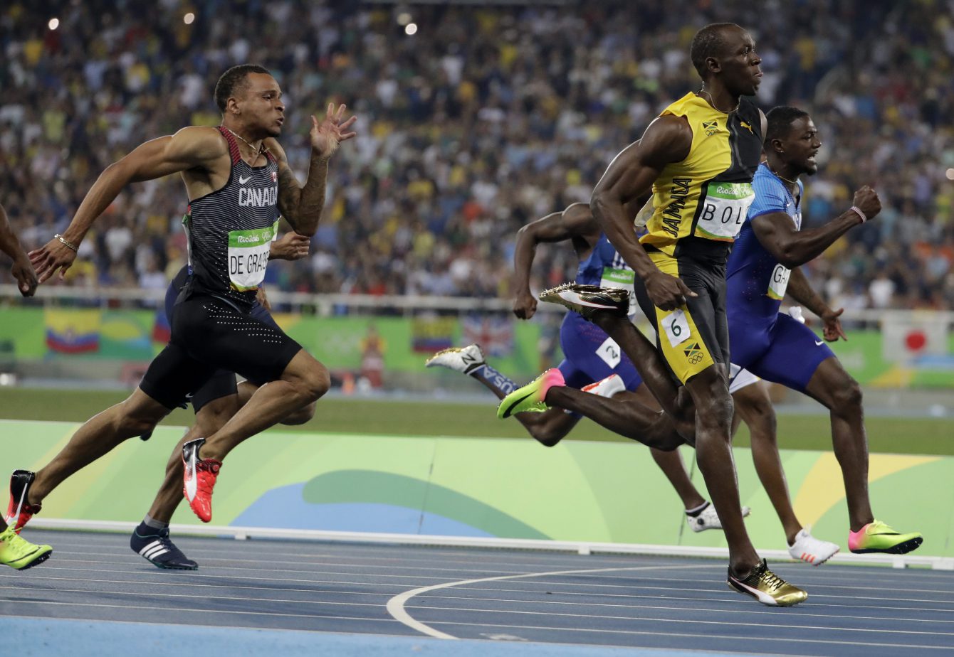 Jamaica's Usain Bolt sprints ahead of Canada's Andre de Grasse, left, and United States' Justin Gatlin in the men's 100-meter final during the athletics competitions of the 2016 Summer Olympics at the Olympic stadium in Rio de Janeiro, Brazil, Sunday, Aug. 14, 2016. (AP Photo/David Goldman)