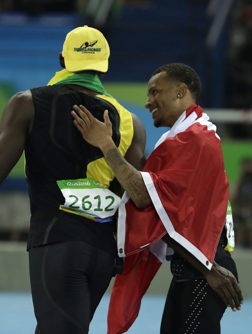 Canada's Andre De Grasse congratulates Jamaica's Usain Bolt after he won the gold medal in the men's 100-meter final during the athletics competitions in the Olympic stadium of the 2016 Summer Olympics in Rio de Janeiro, Brazil, Sunday, Aug. 14, 2016. (AP Photo/Matt Slocum)