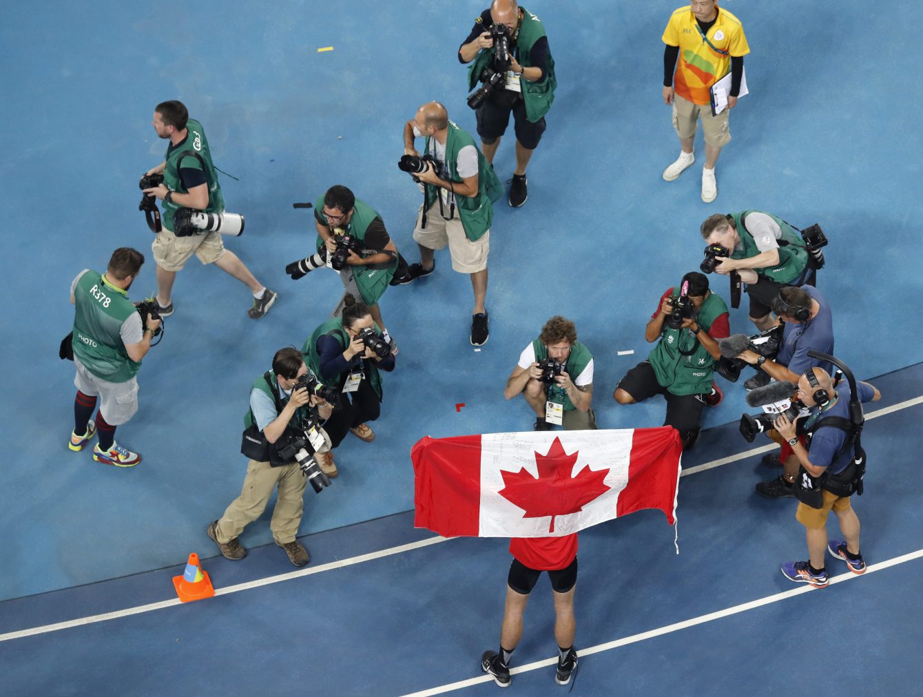 Canada's Derek Drouin poses for pictures after winning the gold medal in the high jump finals during the athletics competitions of the 2016 Summer Olympics at the Olympic stadium in Rio de Janeiro, Brazil, Tuesday, Aug. 16, 2016. (AP Photo/Morry Gash)