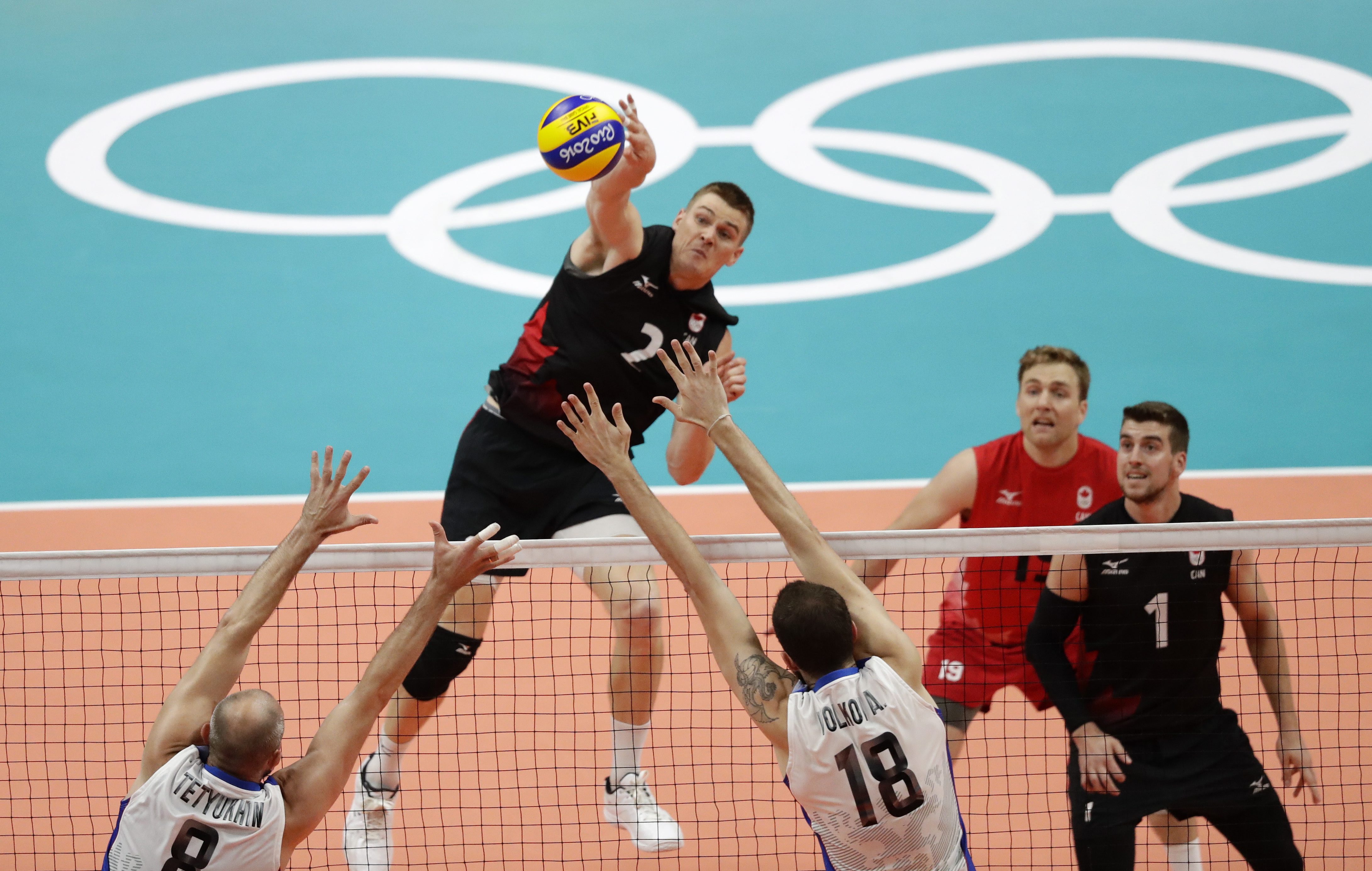 Canada's John Gordon Perrin goes up for a spike that was blocked in a men's quarterfinal volleyball match against Russia at the 2016 Summer Olympics in Rio de Janeiro, Brazil, Wednesday, Aug. 17, 2016. (AP Photo/Robert F. Bukaty)