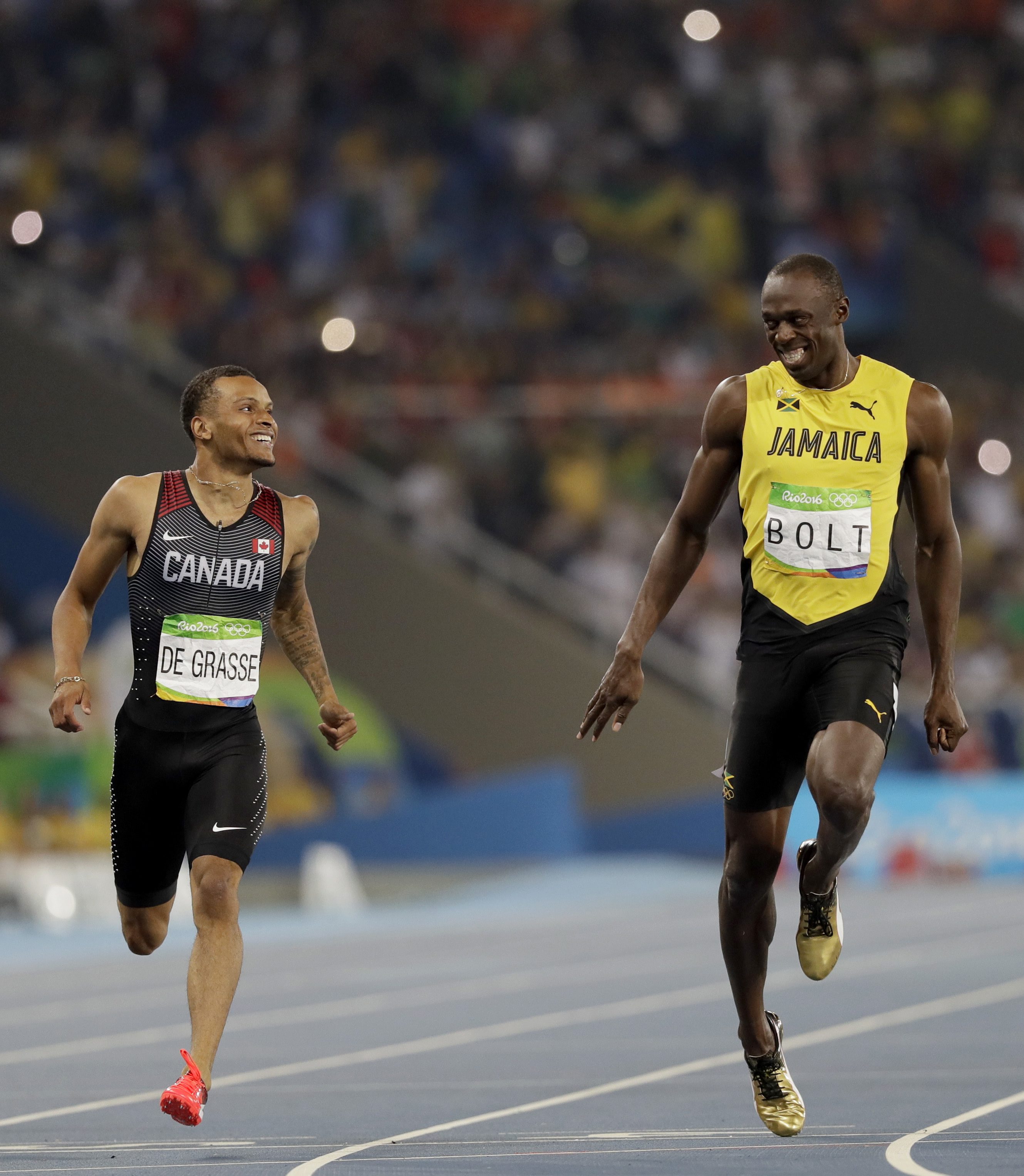 Jamaica's Usain Bolt, right, and Canada's Andre De Grasse compete in a men's 200-meter semifinal during the athletics competitions of the 2016 Summer Olympics at the Olympic stadium in Rio de Janeiro, Brazil, Wednesday, Aug. 17, 2016. (AP Photo/David J. Phillip)