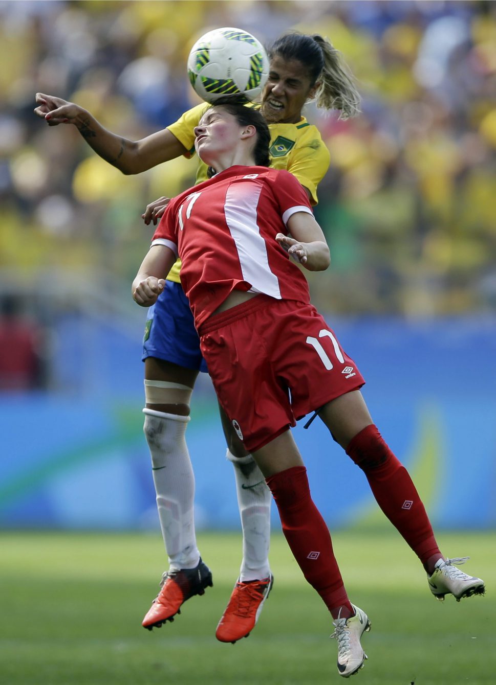 Canada's Jessie Fleming, front, heads the ball under pressure by Brazil's Fabiana during the bronze medal match of the women's Olympic football tournament between Brazil and Canada at the Arena Corinthians stadium in Sao Paulo, Friday Aug. 19, 2016. (AP Photo/Nelson Antoine)