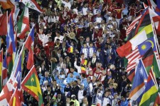 Athletes surrounded by flags march into the closing ceremony in the Maracana stadium at the 2016 Summer Olympics in Rio de Janeiro, Brazil, Sunday, Aug. 21, 2016. (AP Photo/Charlie Riedel)