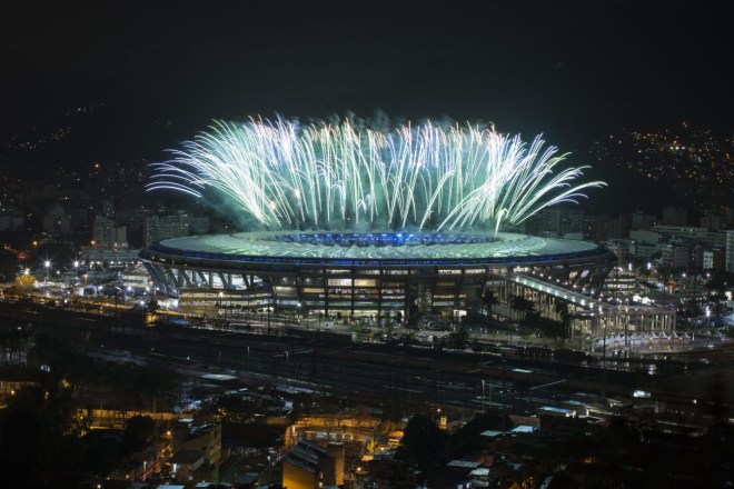 Fireworks explode above the Maracana stadium during the closing ceremony for the Summer Olympics, seen from the Mangueira slum in Rio de Janeiro, Brazil, Sunday, Aug. 21, 2016. (AP Photo/Felipe Dana)