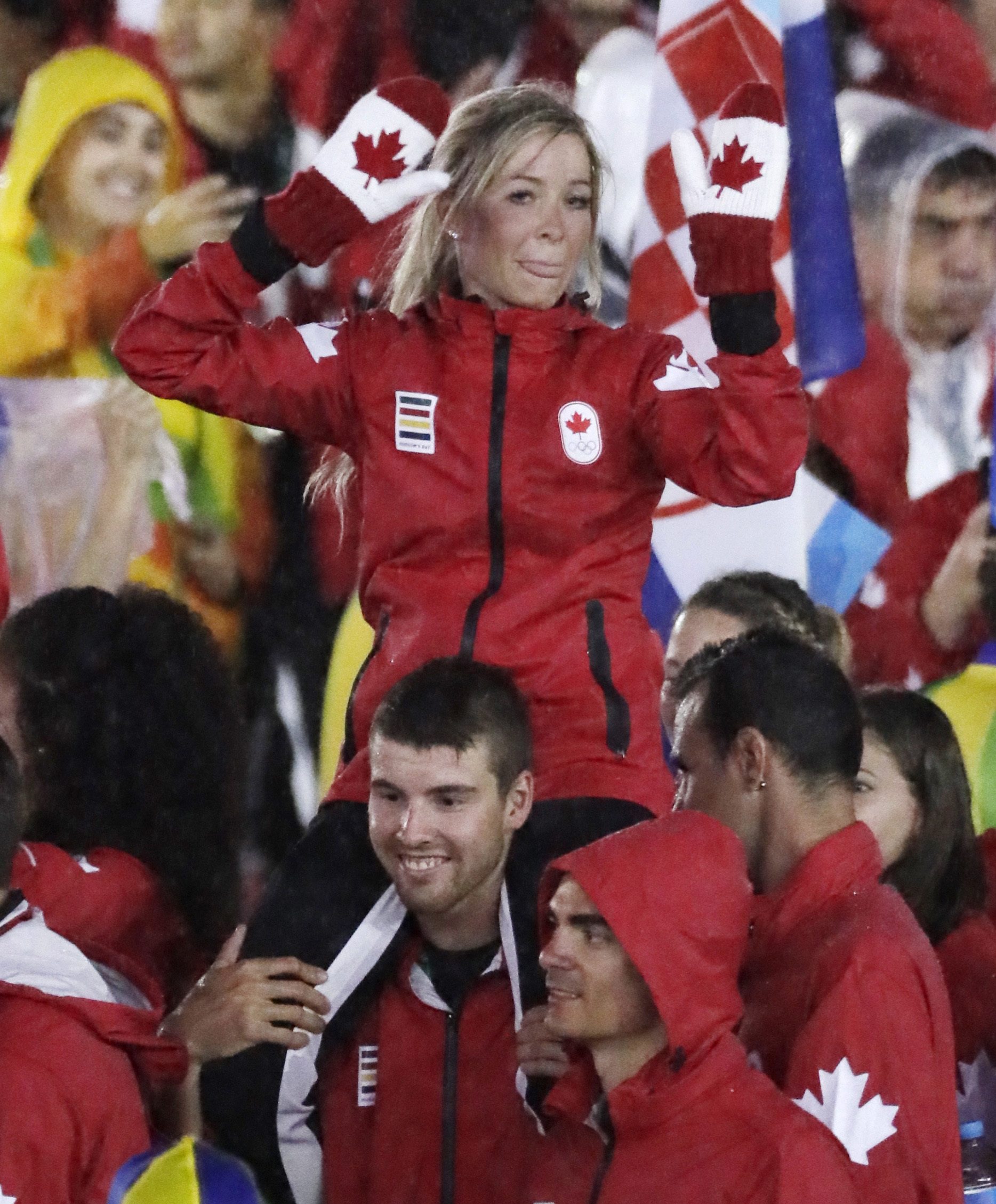 Canadian athlete on shoulders of another Canadian athlete