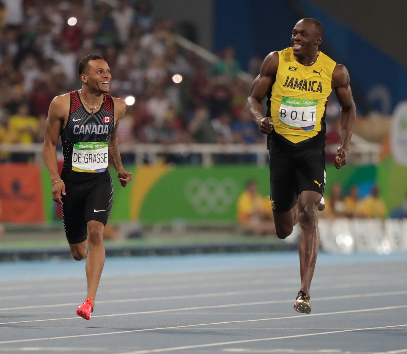 Andre De Grasse (left) and Usain Bolt share a laugh at the finish line in the semifinals of the Olympic 200m on August 17, 2016 in Rio de Janeiro. 