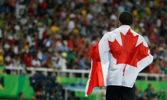 Rio 2016: Andre De Grasse 200m-9 Canada's Andre De Grasse celebrates with his nation's flag after earning a silver medal in the men's 200m final in Rio on August 18, 2016. (photo/ Mark Blinch)