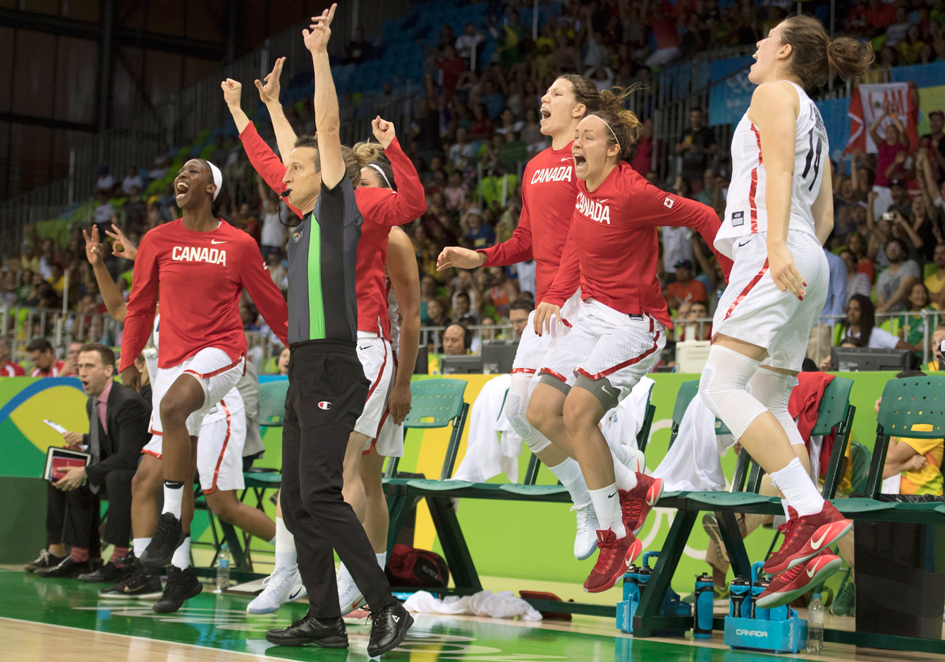 Canada's (left to right) Tamara Tatham, Michelle Plouffe, Shona Thorburn and Katherine Plouffe leap in the air as they celebrate the game-winning shot to defeat Serbia in their preliminary round basketball match at the 2016 Summer Olympics Monday August 8, 2016 in Rio de Janeiro, Brazil. THE CANADIAN PRESS/Frank Gunn
