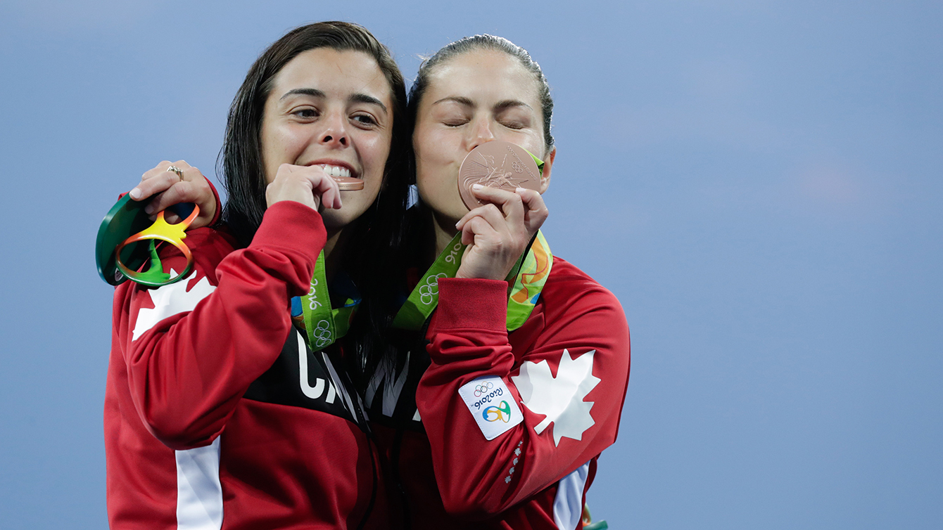 Benfeito and Filion pose with their medals after winning a bronze in the 10m platform synchro dive. (photo/Jason Ransom)