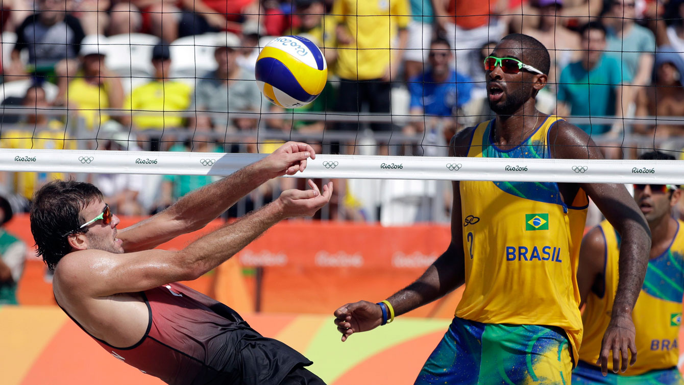 Ben Saxton recovers next to Brazil's Evandro Junior during a men's beach volleyball match at Rio 2016, Brazil, Tuesday, Aug. 9, 2016. (AP Photo/Marcio Jose Sanchez)