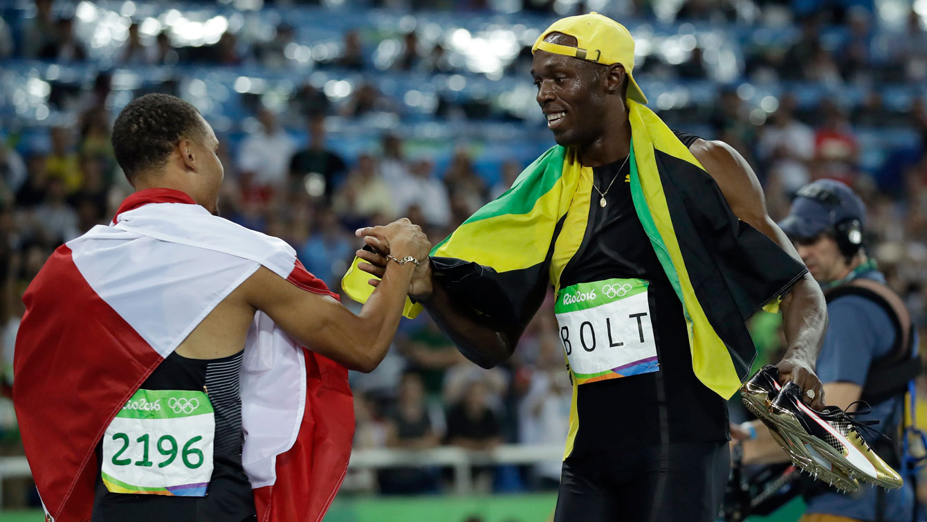 Andre De Grasse (left) and Usain Bolt after their 100m final race at the Olympic Games in Rio de Janeiro on August 14, 2016. 