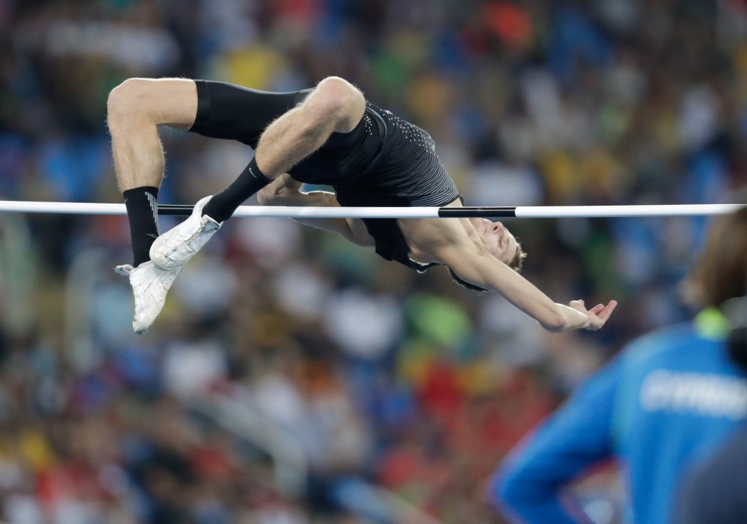 Derek Drouin goes over the high jump bar 