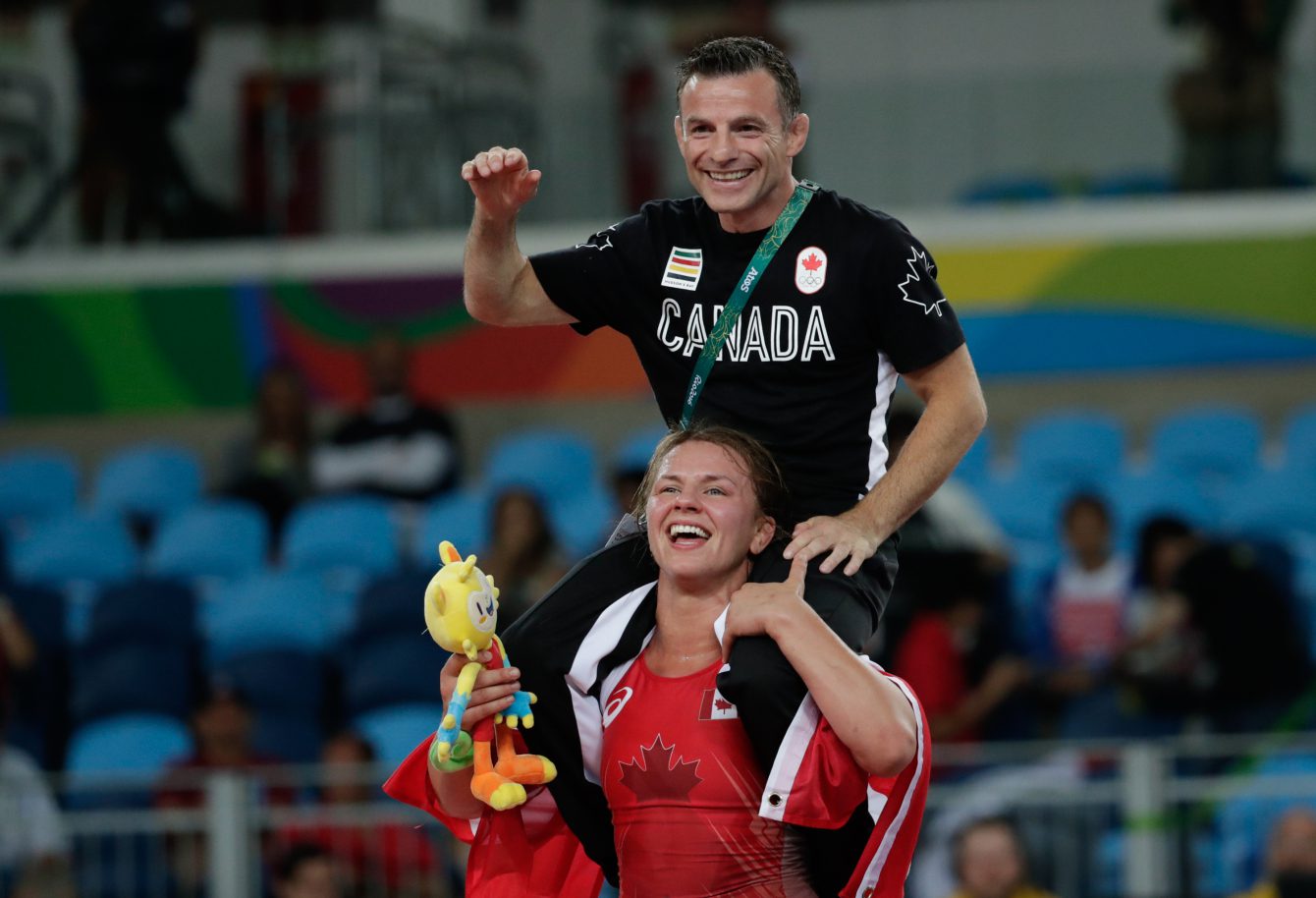 Erica Wiebe carries coach Paul Ragusa after after winning the gold medal during the women's 75kg freestyle wrestling competition at the 2016 Summer Olympics in Rio de Janeiro, Brazil, Thursday, Aug. 18, 2016. photo/ David Jackson