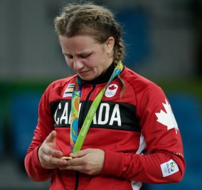 Erica Wiebe looks at her 75kg wrestling gold medal at the 2016 Olympic Games in Rio (Photo: COC/David Jackson)