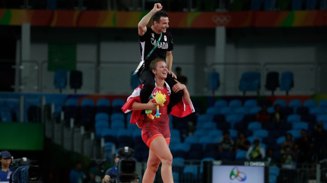 Erica Wiebe carries coach Paul Ragusa on her shoulders after winning