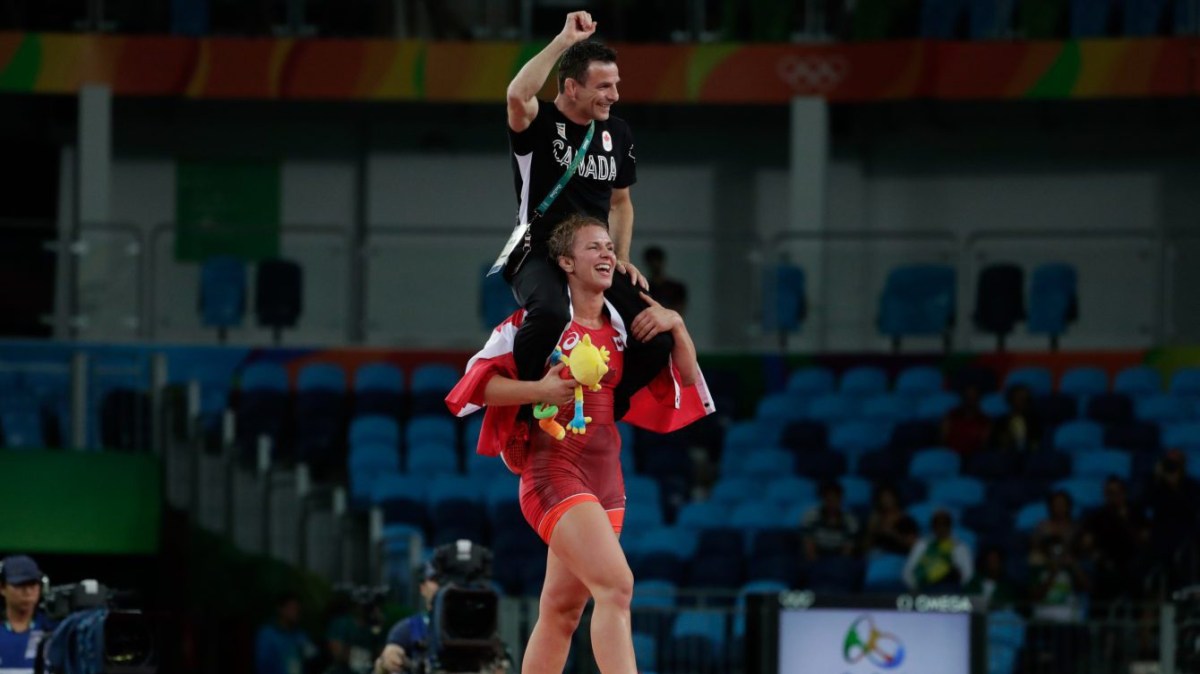 Erica Wiebe carries coach Paul Ragusa on her shoulders after winning