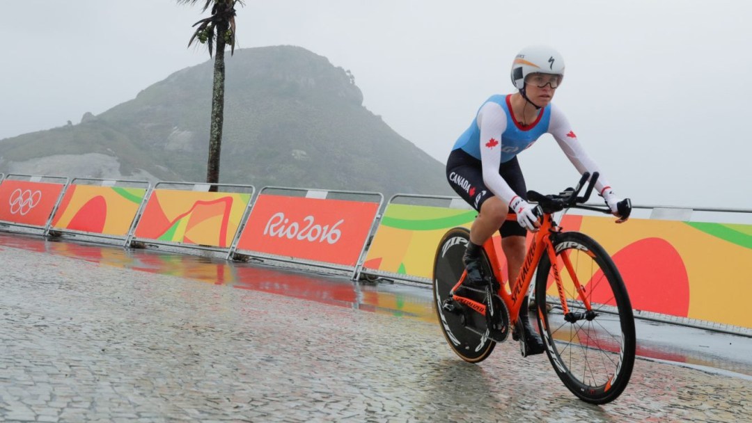 Karol Ann Canuel bikes in the rain in Rio