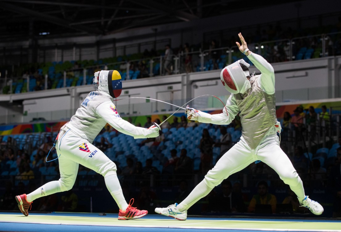 Canada's Maximilien van Haaster, right, competes against against Venezuela's Antonio Leal in their Men's Foil Individual Table of 64 fencing match