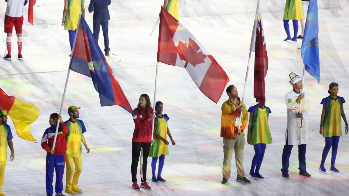 Penny Oleksiak carries the flag in the closing ceremonies during Rio 2016 on August 21, 2016. (COC/Steve Bourdreau)