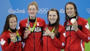 Canada's Katerine Savard, Taylor Ruck, Brittany Maclean and Penny Oleksiak, from left, hold up their bronze medals during the women's 4 x 200-meter freestyle relay medals ceremony during the swimming competitions at the 2016 Summer Olympics, Thursday, Aug. 11, 2016, in Rio de Janeiro, Brazil.