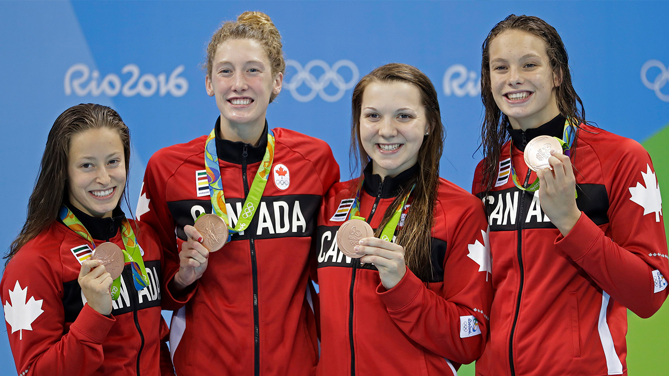 Canada's Katerine Savard, Taylor Ruck, Brittany Maclean and Penny Oleksiak, from left, hold up their bronze medals during the women's 4 x 200-meter freestyle relay medals ceremony during the swimming competitions at the 2016 Summer Olympics, Thursday, Aug. 11, 2016, in Rio de Janeiro, Brazil.