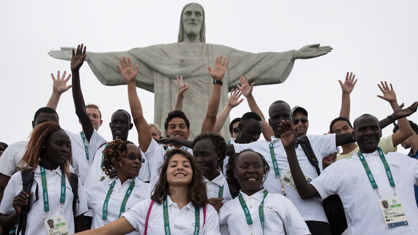 Members of the Refugee Olympic Team pose for a photo in front of the Christ the Redeemer statue in Rio de Janeiro, Brazil, Saturday, July 30, 2016. A group of 10 athletes from South Sudan, Syria, Congo and Ethiopia will compete in Rio under the Olympic flag. (AP Photo/Felipe Dana)