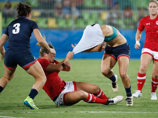 A Great Britain player gets tugged down during their bronze medal match against Canada on August 8, 2016 (photo/ Mark Blinch)