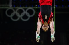 Scott Morgan performs on the rings during men's artistic gymnastics