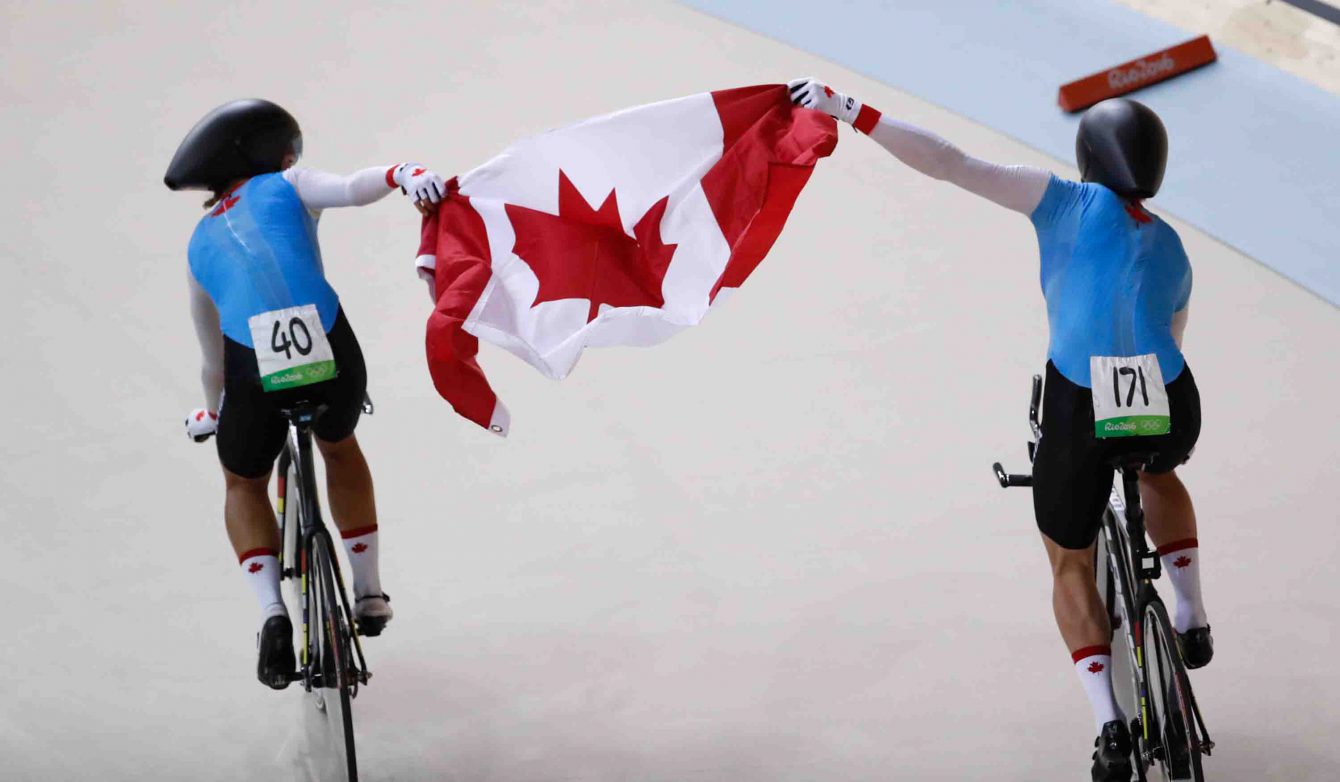 Canada's women's team pursuit team with the Canadian flag after winning the bronze medal at the velodrome at the Olympic games in Rio de Janeiro, Brazil, Saturday August 13, 2016. (photo/ Mark Blinch)