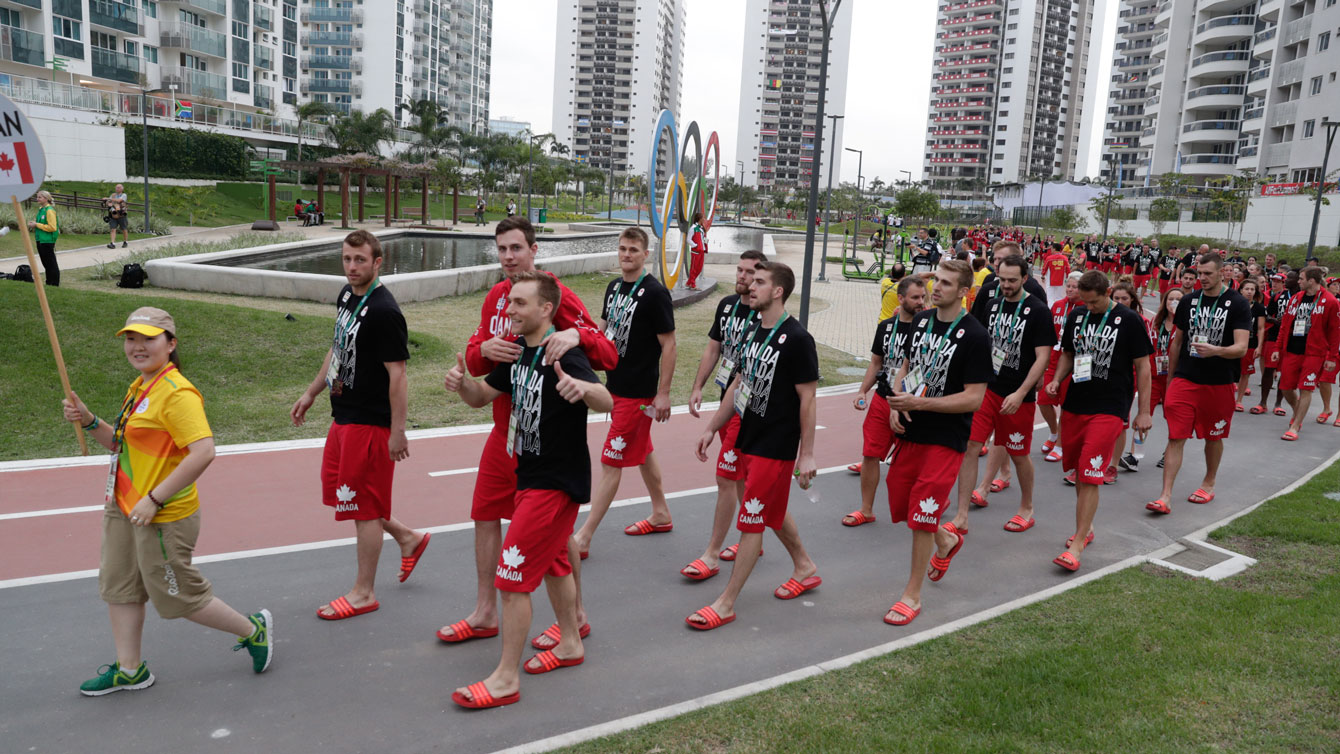 Team Canada marches past the Olympic rings en route to the village welcoming ceremony on August 2, 2016. 