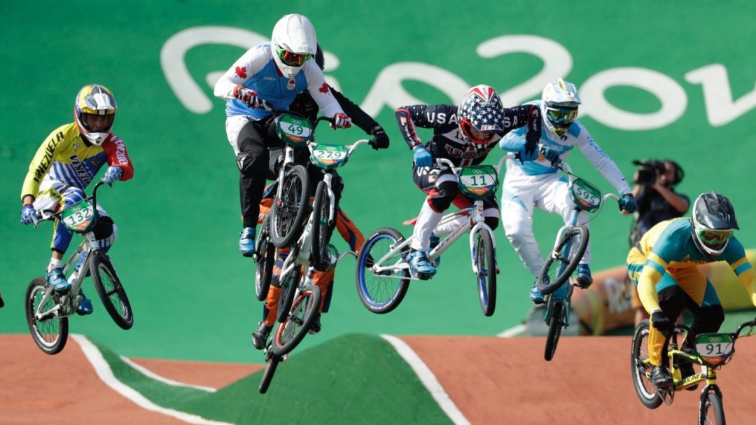 Eight BMX racers go over a race course