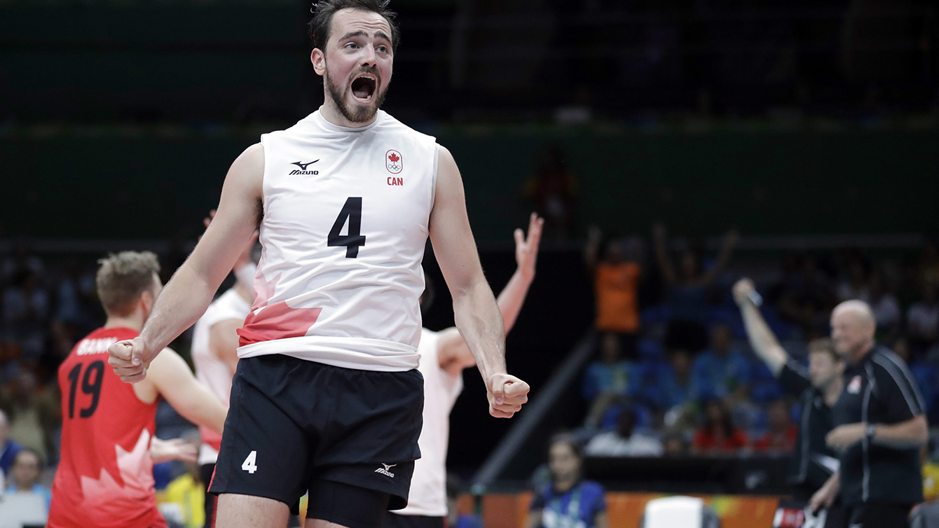 Canada's Nicholas Hoag celebrates after defeating the United States during a men's preliminary volleyball match at the 2016 Summer Olympics in Rio de Janeiro, Brazil, Sunday, Aug. 7, 2016. (AP Photo/Jeff Roberson)
