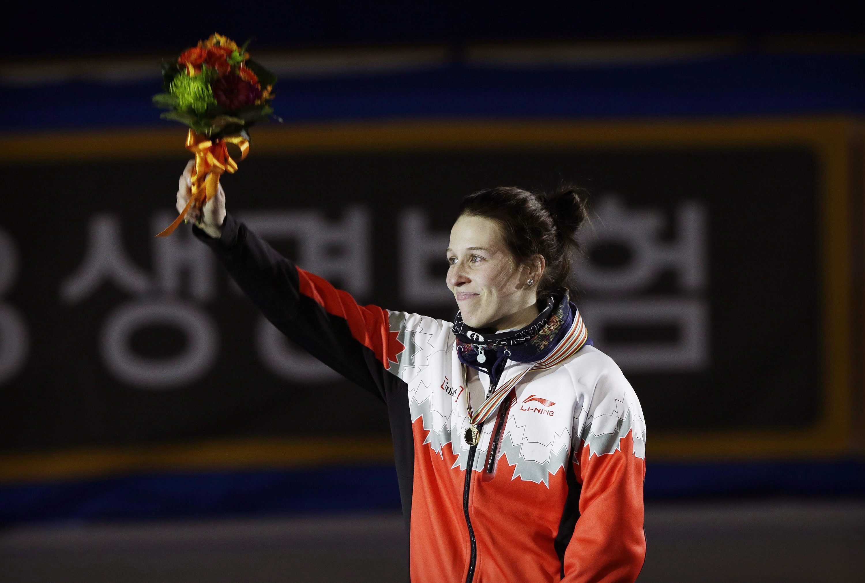 Gold medalist Marianne St-Gelais of Canada celebrates during the awards ceremony of the women's 1500 meter final at the ISU World Cup Short Track Speed Skating in Seoul, South Korea, Saturday, March 12, 2016. (AP Photo/Ahn Young-joon)