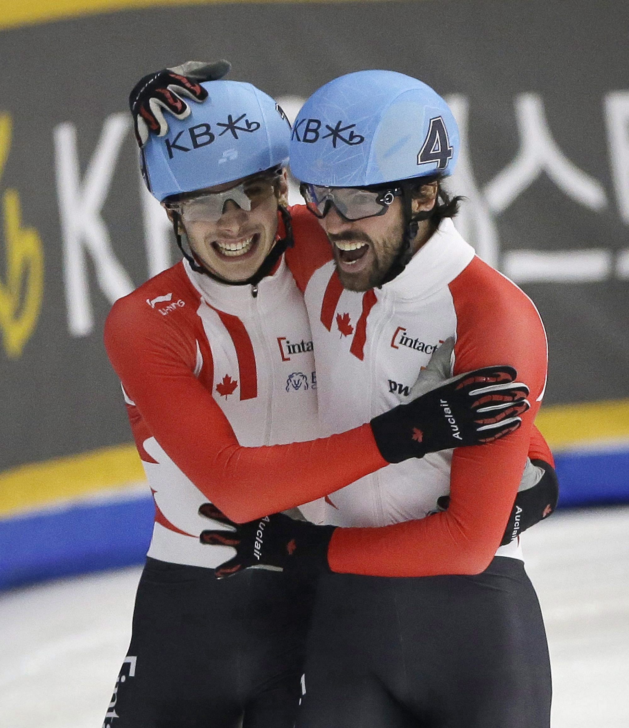 Charles Hamelin, right, and Samuel Girard of Canada celebrate after the men's 1000 meter final race at the ISU World Cup Short Track Speed Skating competition in Seoul, South Korea, Sunday, March 13, 2016. Hamelin won the race while Girard took second. (AP Photo/Ahn Young-joon)