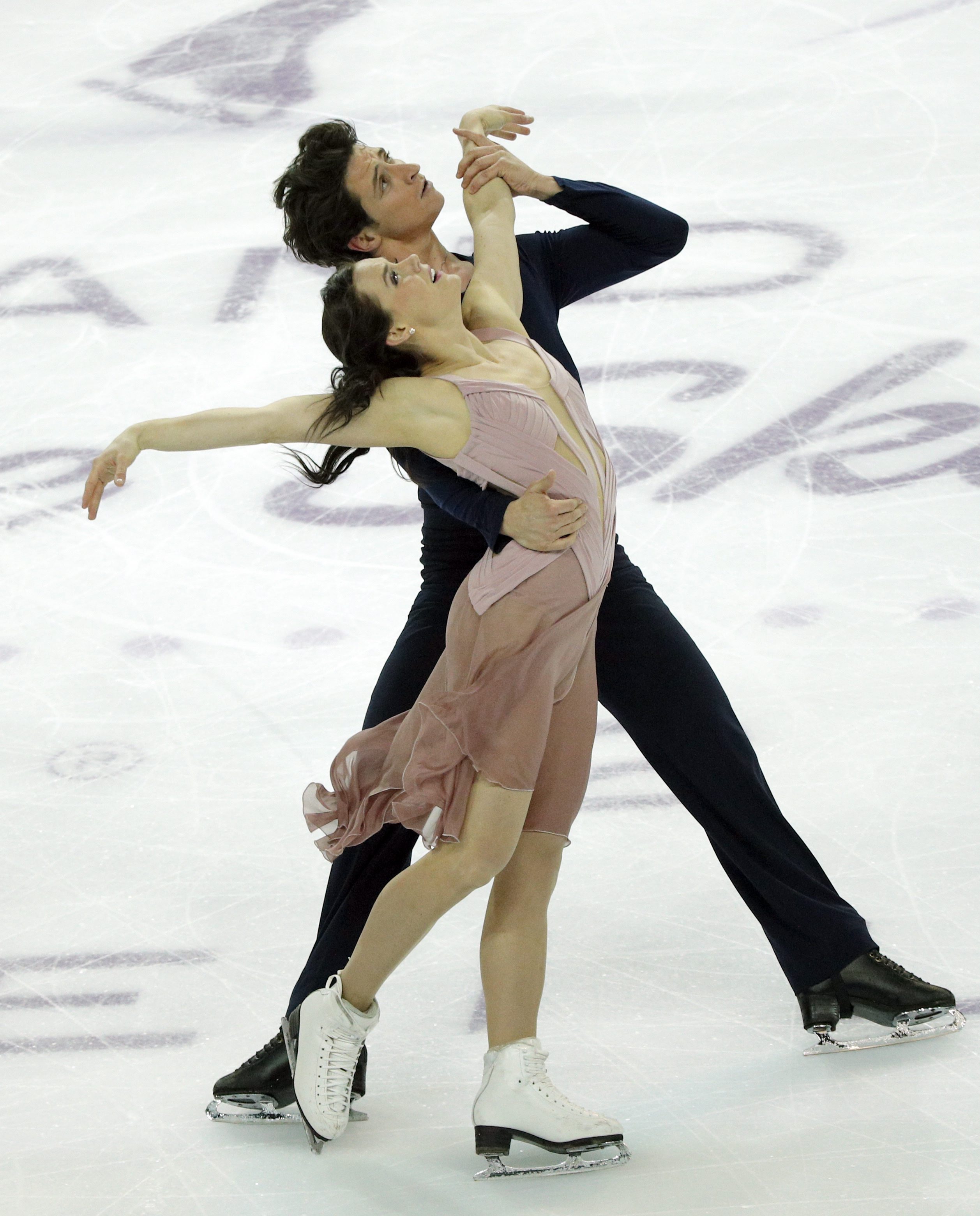 Tessa Virtue and Scott Moir of Canada compete in the Ice Dance Free Dance Program during ISU Grand Prix of Figure Skating Final in Marseille, southern France, Saturday, Dec. 10, 2016. (AP Photo/Christophe Ena)
